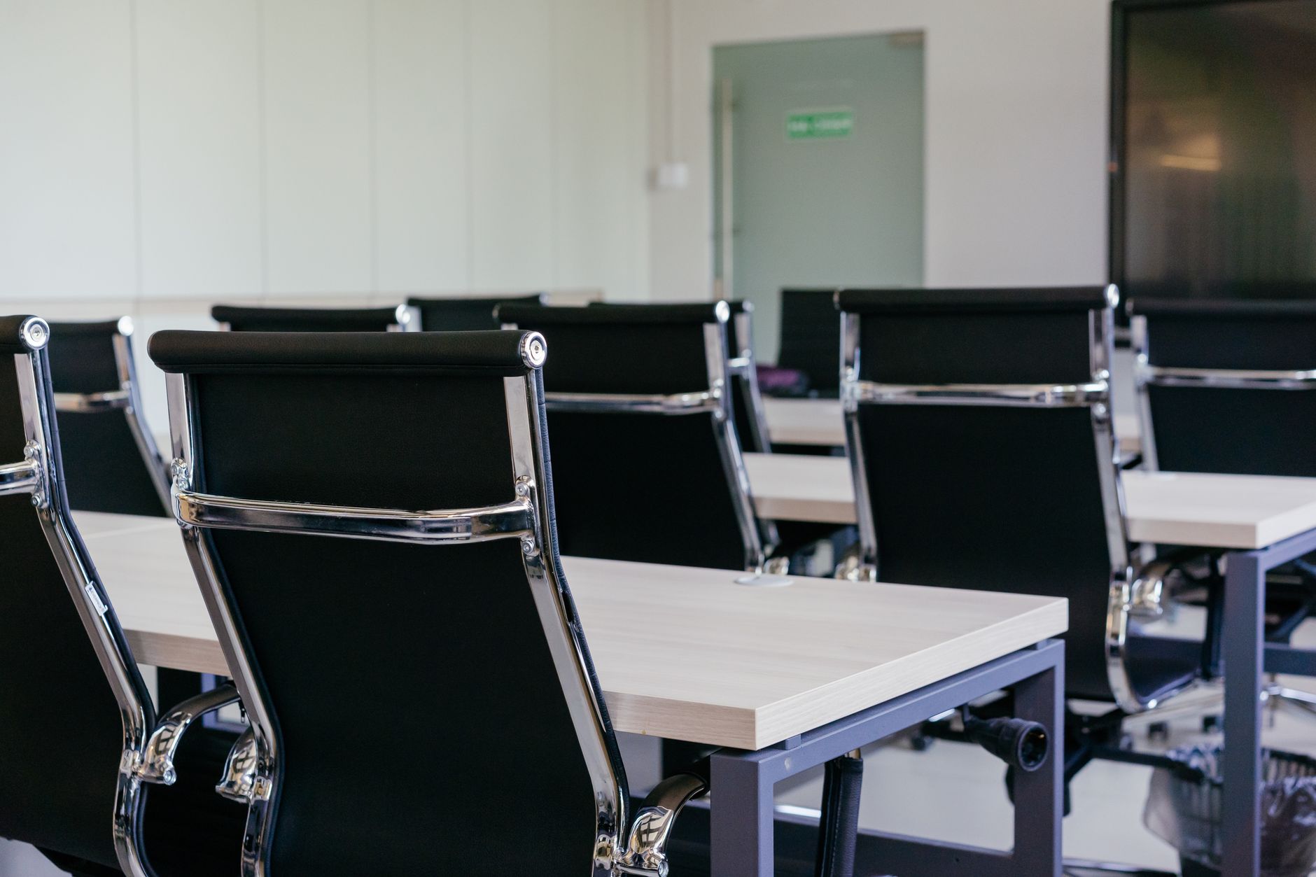 Rows of classroom chairs and pale desks