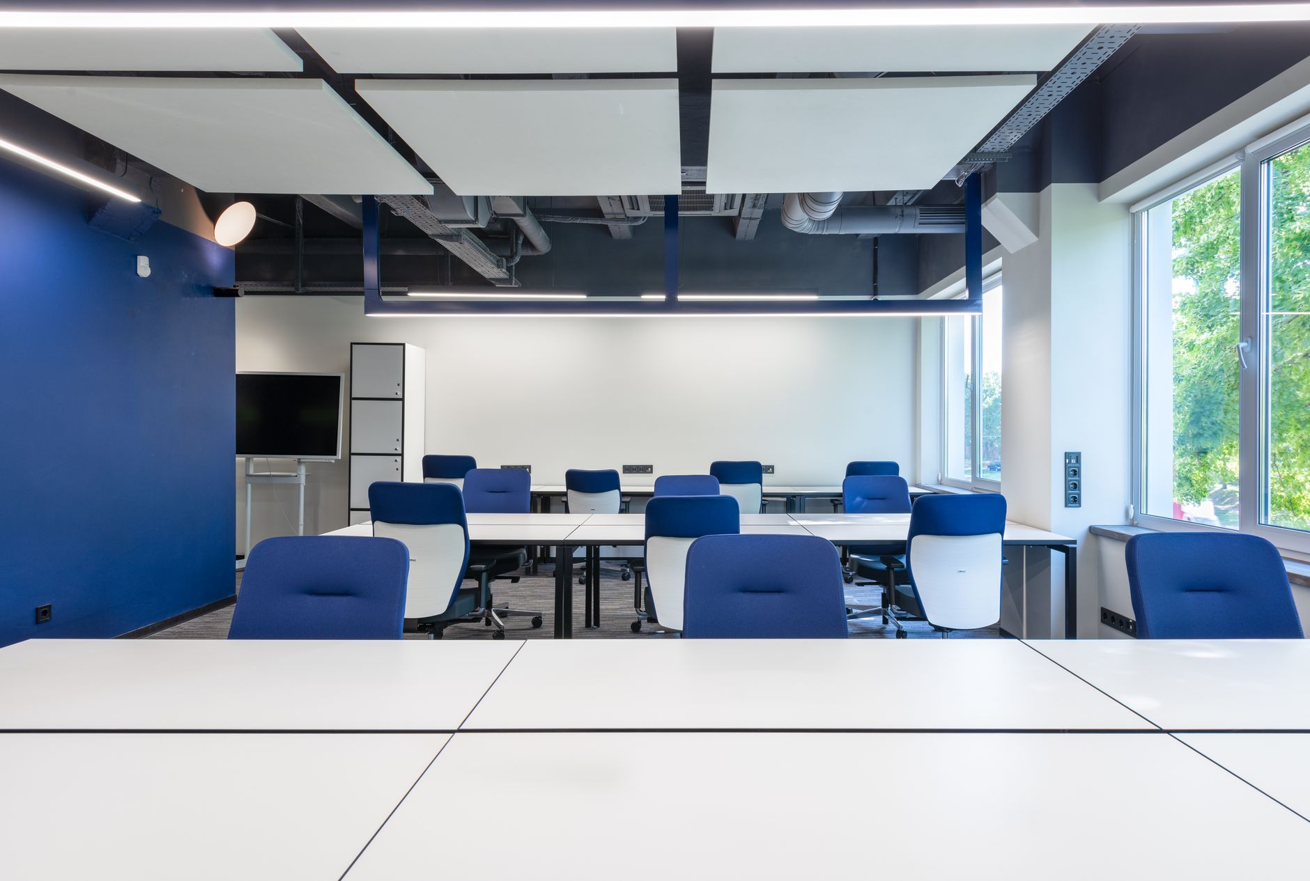 The teaching room with tables and blue chairs